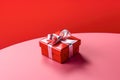 Red gift box with ribbon and bow isolated on red background.Holiday gift with Birthday, Christmas present, flat lay, top view, Royalty Free Stock Photo