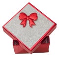 Red gift box with shinny silver cover and red bow, close up, isolated. Royalty Free Stock Photo