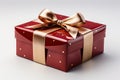 Red gift box with shiny gold ribbon on white background.