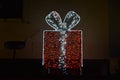 red gift box with a white bow, light installation Royalty Free Stock Photo