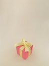 Red gift box with yellow ribbon on beige background. vertical Royalty Free Stock Photo