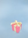 Red gift box with yellow ribbon on blue background. vertical. Royalty Free Stock Photo