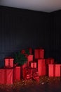 Red gift boxes in dark interior. Presents concept. Christmas and Black Friday.