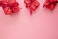 Red gift boxes with ribbon on pink background, flat lay, Valentine's Day, copy space. Frame, border, mock up Royalty Free Stock Photo