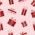 simple seamless pattern with red gift boxes, ribbons and bows on pink background Royalty Free Stock Photo