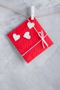 Red gift card wih paper hearts on gray concrete background. Royalty Free Stock Photo