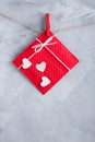 Red gift card wih paper hearts on gray concrete background. Royalty Free Stock Photo