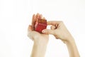 Red gift in gentle hands of a young girl, on a white isolated background Royalty Free Stock Photo