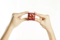 Red gift in gentle hands of a young girl, on a white isolated background Royalty Free Stock Photo