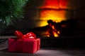 A Christmas tree bauble near a burning fireplace. Close-up Royalty Free Stock Photo