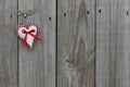 Red gingham and muslin hearts hanging on wood door