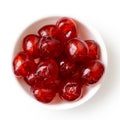 Red glace cherries in white bowl isolated on white from above. Royalty Free Stock Photo