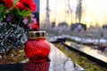 Red glass candle lattern on the grave. Royalty Free Stock Photo