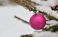 Red glass Christmas ball on Christmas tree with snow as background Royalty Free Stock Photo