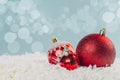 Red glass Christmas balls in the snow on a blue background with bokeh lights. happy new year card Royalty Free Stock Photo