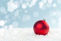 Red glass Christmas balls in the snow on a blue background with bokeh lights. happy new year card Royalty Free Stock Photo