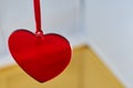 A red glass heart with a blurred background. Royalty Free Stock Photo