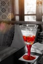Red Glass Of Water On The Table With Sun Light Royalty Free Stock Photo