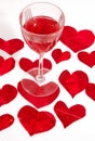 Red glass of wine and red hearts