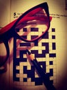 Intellectual leisure. Crossword, glasses and pencil.