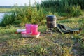 Red glasses, pot and gas burner, breakfast tourist on the waterfront