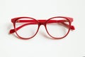 Red glasses on white background