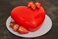 Red glaze mousse cake, heart shape form on dark background Royalty Free Stock Photo