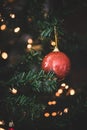 Red glitter ball on Christmas, New Year decorated fur tree Royalty Free Stock Photo