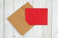 Red glitter blank greeting card and envelope on weathered whitewash textured wood background Royalty Free Stock Photo