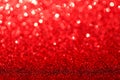 Red glitter foil Christmas background. Shiny metal red foil texture abstract defocused background. Sparkle glitter texture with Royalty Free Stock Photo