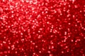 Red glitter foil Christmas background. Shiny metal red foil texture abstract defocused background. Sparkle glitter texture with Royalty Free Stock Photo
