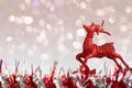 Red glitter reindeer ornament on white snow with abstract background Royalty Free Stock Photo