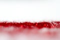Red glitter texture on white background. Defocused. Royalty Free Stock Photo