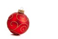 A red, glittery Christmas ornament on white