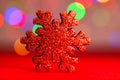 Red glittery decoration in a colorful Christmas composition isolated on background of blurred lights Royalty Free Stock Photo