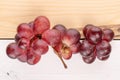 Red globe grape on wood Royalty Free Stock Photo