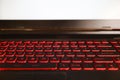 Red glowing back lit keyboard of a gaming laptop with white mockup screen Royalty Free Stock Photo