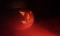 Red glowing fog and a grinning Halloween pumpkin