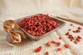 Red goji beans in a wooden cup - country style