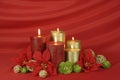 Red and gold burning candles on an elegant red fabric backdrop Royalty Free Stock Photo