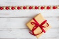Red and gold christmas balls and gift box on a white wooden background. The concept of the celebration Royalty Free Stock Photo