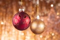 Red and gold Christmas baubles on background of defocused golden lights. Royalty Free Stock Photo