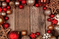 Red and gold Christmas ornament frame, top view on a rustic wood background Royalty Free Stock Photo