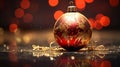 a red and gold christmas ornament on a shiny surface Royalty Free Stock Photo