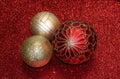 Red and Gold Christmas Ornaments on Red Glitter Background Royalty Free Stock Photo