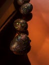 Red gold coloured easter eggs, lying down on a red surface with a blurred reflection. Spring holidays