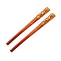 Red and gold decorative chopsticks lying on a white surface with intricate designs Royalty Free Stock Photo