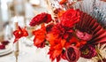 Red gold golden color decor, floral arrangement. Festive bouquet, table decoration. Traditional Chinese New Year party Royalty Free Stock Photo