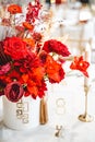 Red gold golden color decor, floral arrangement. Festive bouquet, table decoration. Traditional Chinese New Year party Royalty Free Stock Photo