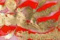 Red and gold paint liquid background. Abstract rich texture.